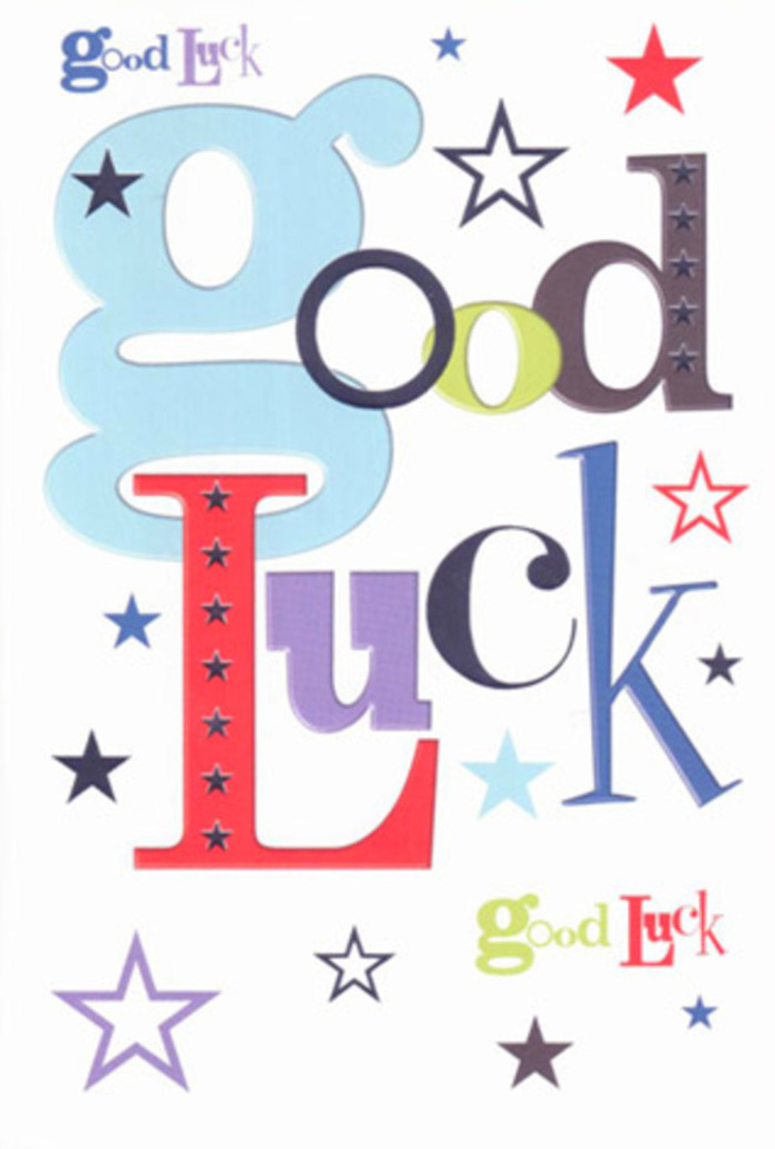 The photograph captures a wonderfully upbeat good luck card, designed with the same sense of joy and balance that goes into arranging a celebratory bouquet for someone heading off to a big opportunity in or beyond Lea Bridge. At the heart of the card, the words Good Luck stretch across the white surface in a lively combination of fonts: broad, rounded letters in soft pastel blue mingle with slim, upright strokes of charcoal black and moss green, while confident splashes of red and deep purple punctuate the phrase like exclamation points made of colour. Every letter is slightly different, yet together they form a cohesive, rhythmic pattern that feels almost like a chorus of voices cheering from the sidelines. The stark white background acts like generous negative space, giving all the colours room to breathe, similar to the way a florist leaves pockets of air between stems so each bloom can shine. Scattered across this crisp canvas are countless stars and tiny dots in varying intensities of navy, teal, sky-blue, lavender, and muted lime, some sharp and defined, others so faint they resemble chalky pastel marks; they drift in loose constellations around the text, suggesting the idea that luck is swirling in the air, waiting to settle on the person receiving the card. The cardstock appears sturdy and smooth, with a subtle softness that would feel reassuring under your fingers, echoing the tactile satisfaction of holding a ribboned bouquet. The atmosphere is optimistic and warm, as if this card has been chosen to accompany flowers delivered to a doorstep near the Lea Bridge roundabout or to a colleague's desk overlooking the marshes, quietly infusing their new chapter with colour, encouragement, and the sense that their community is rooting for them.