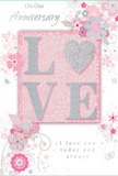 This anniversary card design offers a gentle, romantic atmosphere, blending soft pastel pinks with silvery greys to create the feeling of a quiet celebration in a Lea Bridge townhouse at dusk. At the centre, the word LOVE is spelled out in raised letters, their surfaces coated in a fine, soft glitter that catches the light in a subtle shimmer. The letter O is cleverly replaced with a small, sparkling heart, filled with more intense silver texture, giving the focal point a sense of warmth and devotion. Around this, delicate blooms in blush pink and soft mauve unfurl with a watercolor-like softness, as if carefully painted by hand. Their fine outlines and gentle washes of colour mimic the artistry seen in the romantic arrangements prepared for couples celebrating along Lea Bridge Road or by the River Lea. Leafy tendrils and flowing swirls interlace between the blossoms, creating a light, dancing movement across the card. Tiny details-scattered petals, small flourishes, and faint butterflies-add a note of whimsy, reminiscent of an English spring garden just as buds open in nearby Springfield Park. The surrounding background is a muted, rosy pink, smooth and calm, allowing the glittered LOVE and soft florals to stand out clearly without overwhelming the eye. Elegant script phrases such as On Our Anniversary and I love you today and always appear in flowing, understated lettering, their curves echoing the motion of the vines. The overall effect is refined yet intimate, like a hand-tied bouquet translated into paper, ideal for marking the shared journey of two people who have grown together in Lea Bridge, year after year.